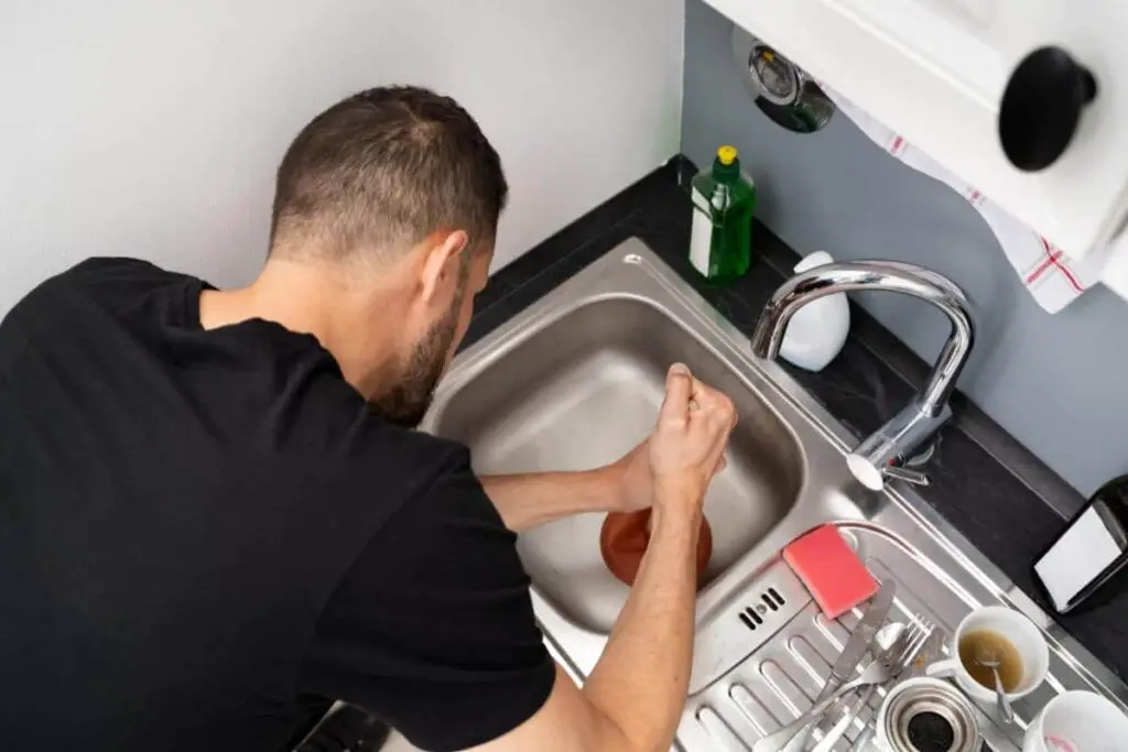 Why kitchen sink clogged past trap?